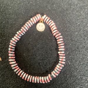 Clay bead bracelet with metal smiley face charm
